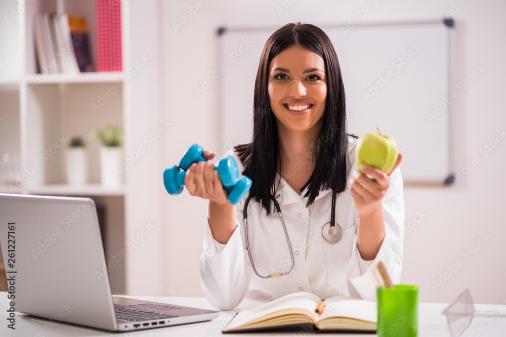 Young doctor is talking about importance of fitness and healthy eating. Young doctor is talking about importance of fitness and healthy eating.