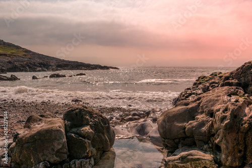 The coastline around gower, Wales with the waves conming into land photo