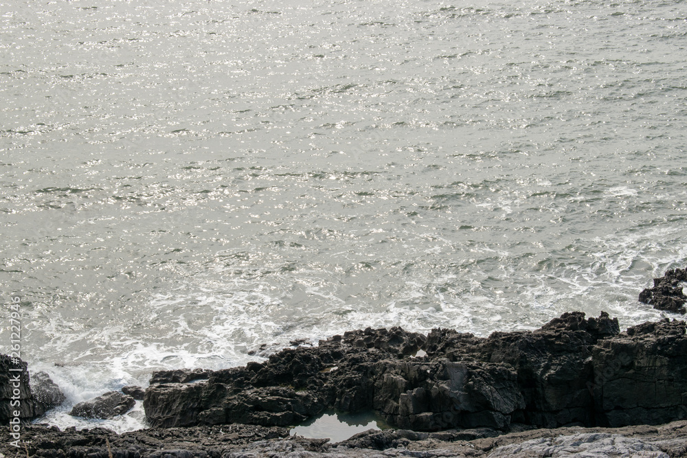 The coastline around gower, Wales with the waves conming into land