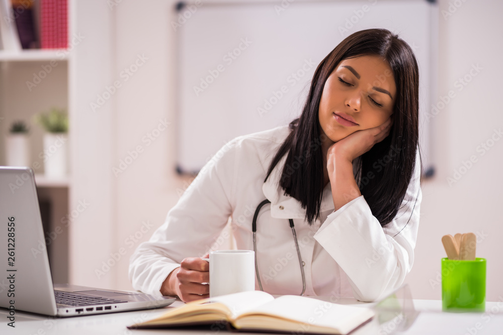 Portrait of tired doctor in her office. Portrait of tired doctor in her office.