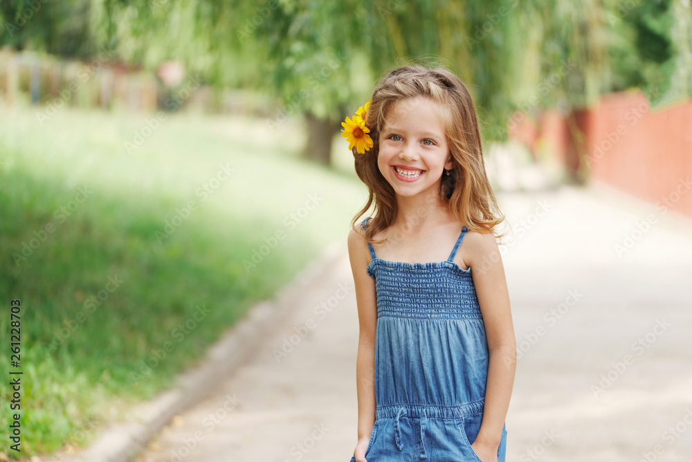 cute beautiful girl with flower behind ear Stock Photo | Adobe Stock