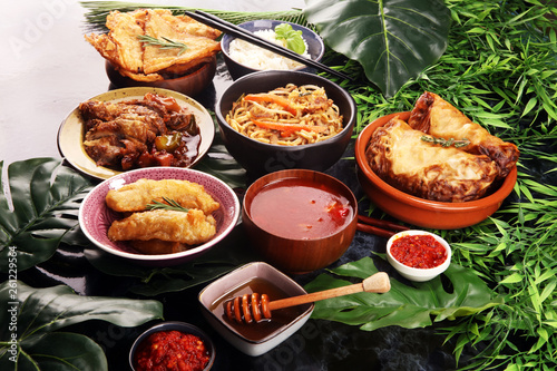 Assorted Chinese food set. Chinese noodles  fried rice  peking duck  dim sum  spring rolls. Famous Chinese cuisine dishes on table. Chinese restaurant
