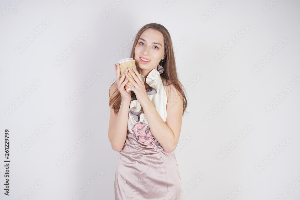 cute teenager caucasian girl in fashionable evening dress with paper coffee Cup on white background in Studio alone cute teenager caucasian girl in fashionable evening dress with paper coffee Cup on white background in Studio alone