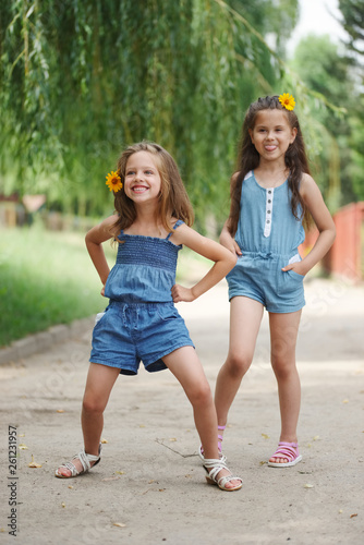 photo of two little girls in summer park