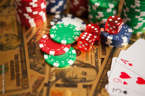 Vászonkép Casino red dices and casino poker chips on golden US Dollar bills