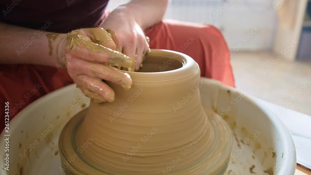 Experienced potter creating a beautiful clay vase using professional tools Experienced potter creating a beautiful clay vase using professional tools