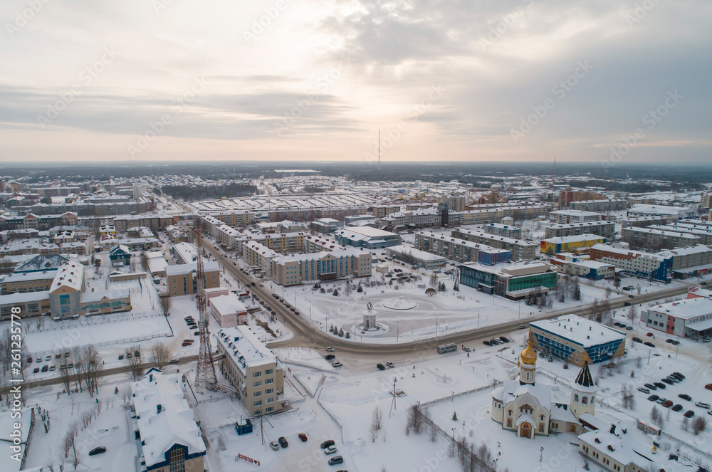 Church and city administration building  in Yugorsk city. Aerial. Winter, snow, cloudy. Khanty Mansiysk Autonomous Okrug (HMAO), Russia.