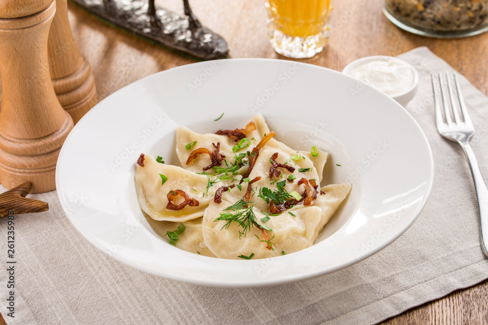 ravioli stuffed with spinach and ricotta with cheese italian food on wooden table