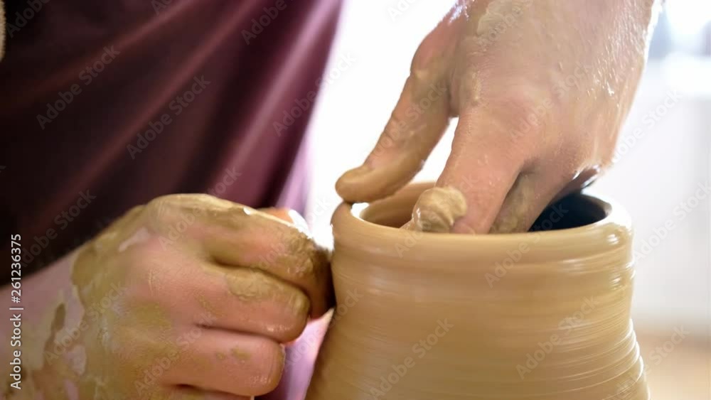 Experienced potter creating a beautiful clay vase using professional tools Experienced potter creating a beautiful clay vase using professional tools