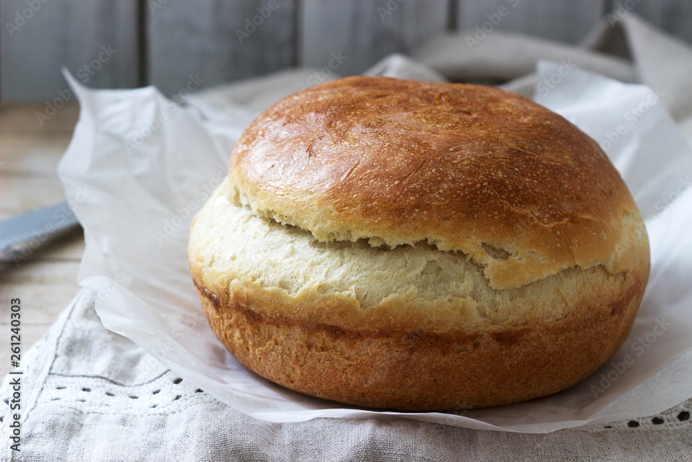 Fresh homemade wheat yeast bread on a linen tablecloth. Rustic style. Fresh homemade wheat yeast bread on a linen tablecloth. Rustic style.