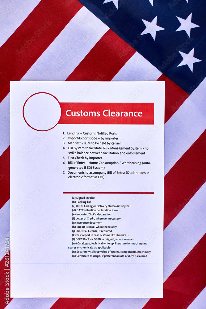 Page with the rules of customs clearance on American flag background. Close-up Page with the rules of customs clearance on American flag background. Close-up
