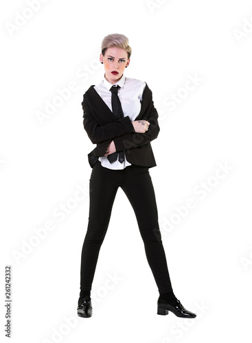 Attitude woman with a suit, shirt and tie, isolated, full body on white background. The masculine girl has short blonde hair and suit jacket bunched up off her shoulders in a messy, yet stylish way