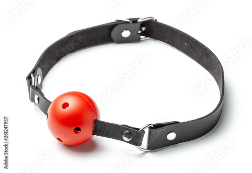Red Ball gag in mouth isolated on white background. Intimate toys. Sex abuse slavery