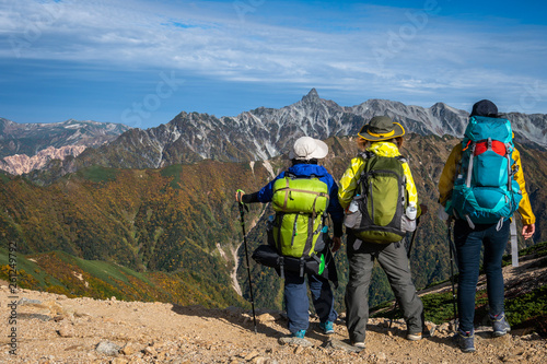 Epic adventure of hiker do trekking activity in mountain of Northern Japan Alps, Nagano, Japan, with panoramic nature mountain range landscape. Motivation leisure sport and discovery travel concept. photo