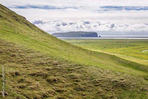 Distance view of Dyrholaey foreland located on the south coast of Iceland