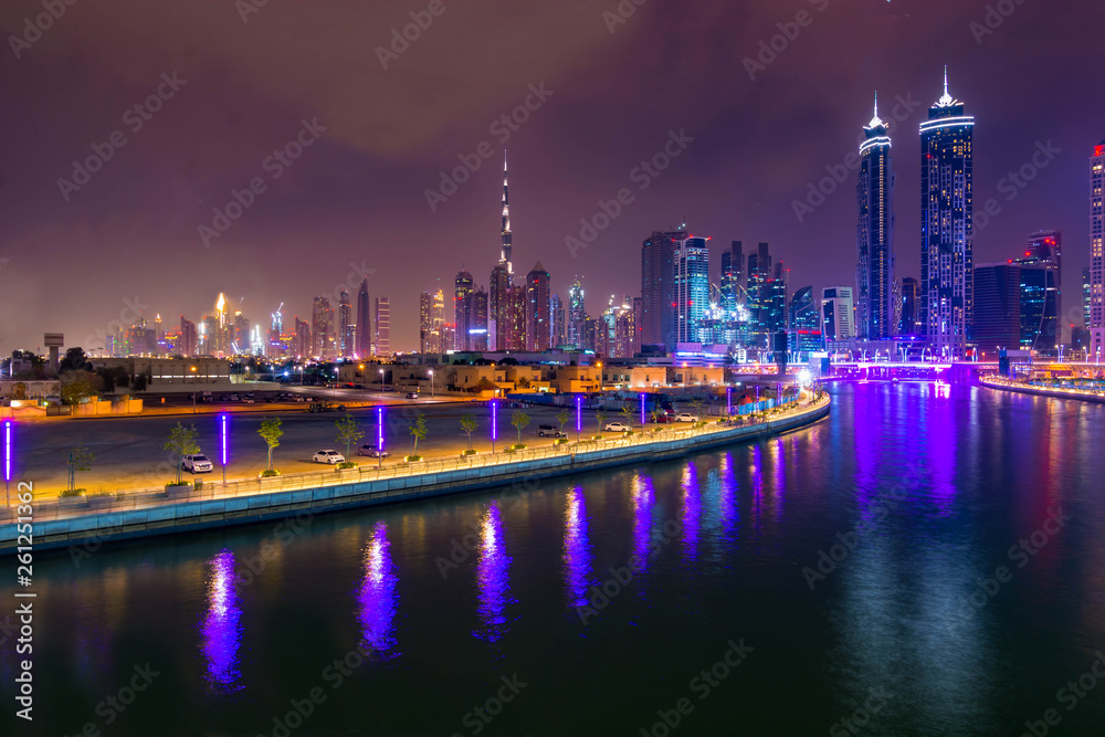 Fototapeta premium Aerial view of light illuminated futuristic skyscrapers in downtown