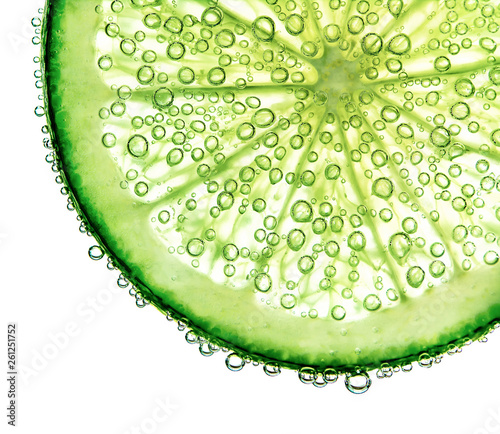 Fresh lime floating in frozen water