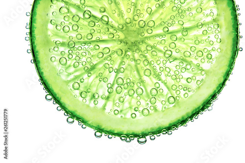 Fresh lime floating in frozen water