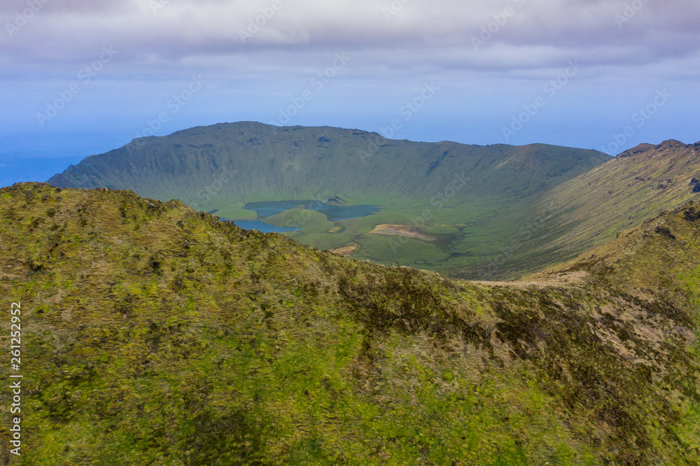 Fototapeta premium Aerial view of volcanic crater (Caldeirao) with a beautiful lake on the top of Corvo island. Azores islands, Portugal.