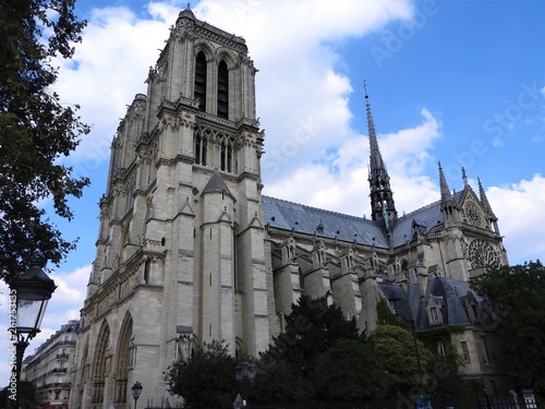 The facade of Notre Dame against the blue sky.