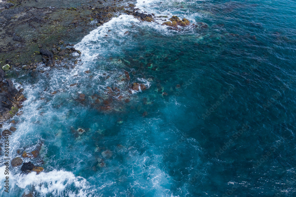 Aerial view to ocean waves. Blue water background. Photo made from above by drone.