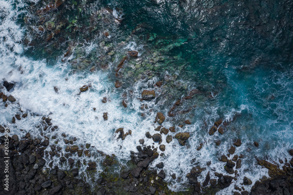 Aerial view to ocean waves. Blue water background. Photo made from above by drone. Aerial view to ocean waves. Blue water background. Photo made from above by drone.