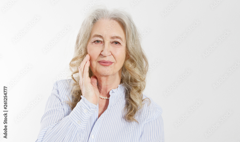 Closeup of smiling senior woman wrinkle face and gray hair. Old mature lady touching her wrinkled skin isolated on white background. Copy space. Banner Closeup of smiling senior woman wrinkle face and gray hair. Old mature lady touching her wrinkled skin isolated on white background. Copy space. Banner