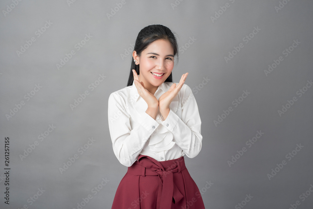 Portrait of beautiful business woman on grey background, studio shot Portrait of beautiful business woman on grey background, studio shot