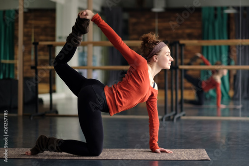 woman practicing yoga, stretching in cat exercise, tiger pose photo