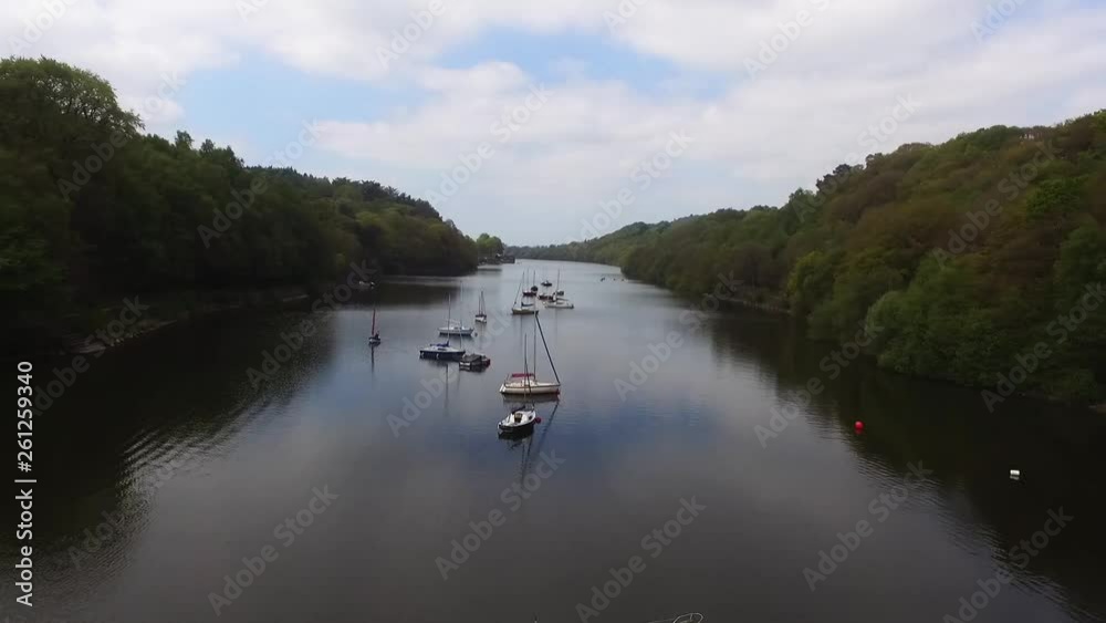 Aerial backwards moving shot of lake with boats on Aerial backwards moving shot of lake with boats on
