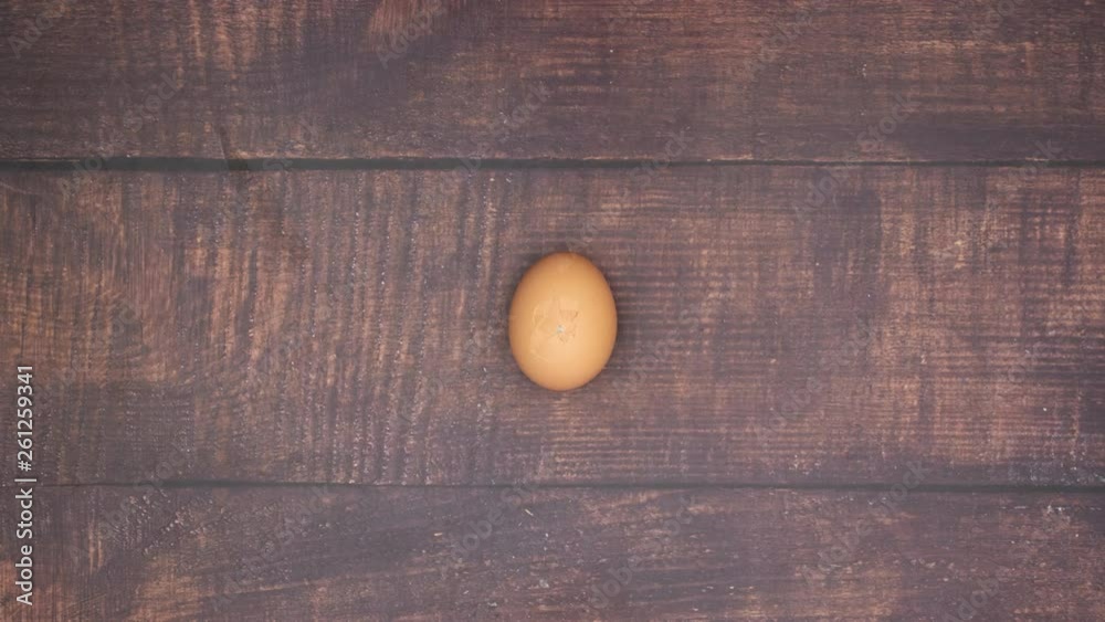Boiled egg on wooden background and peeling an egg - Stop motion 