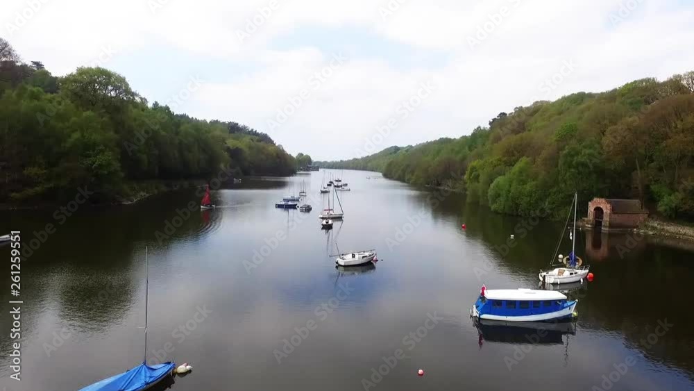 Upward panning shot of lake with boats on Upward panning shot of lake with boats on