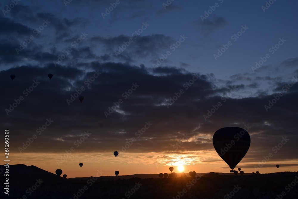 Sunrise and balloons. Beautiful background of the balloon and the sunset.Cappadocia. Turkey. Göreme. Nevşehir. Türkiye. 8. 04. 2019. Balloons flying over the rocky landscape in Cappadocia Turkey. View Sunrise and balloons. Beautiful background of the balloon and the sunset.Cappadocia. Turkey. Göreme. Nevşehir. Türkiye. 8. 04. 2019. Balloons flying over the rocky landscape in Cappadocia Turkey. View