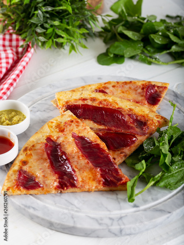 Smoked Ribs pizza with arugula and parmesan cheese on white marble  background