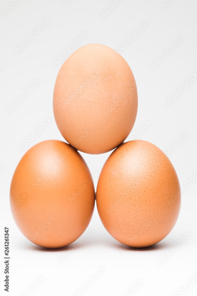 Three chicken eggs in balance pyramid Three chicken eggs in balance pyramid
