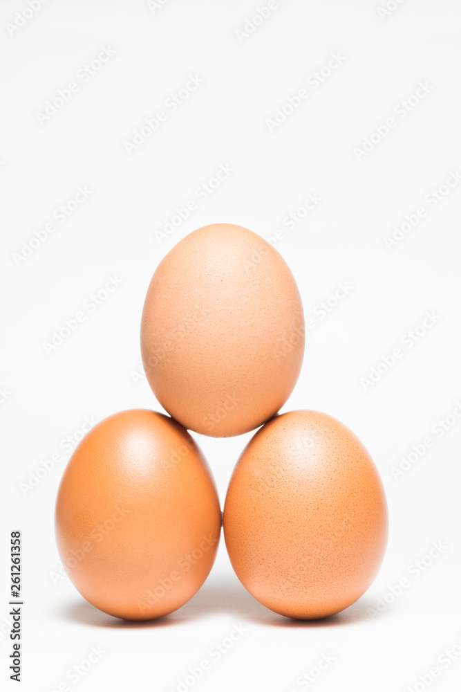Three chicken eggs in balance pyramid Three chicken eggs in balance pyramid