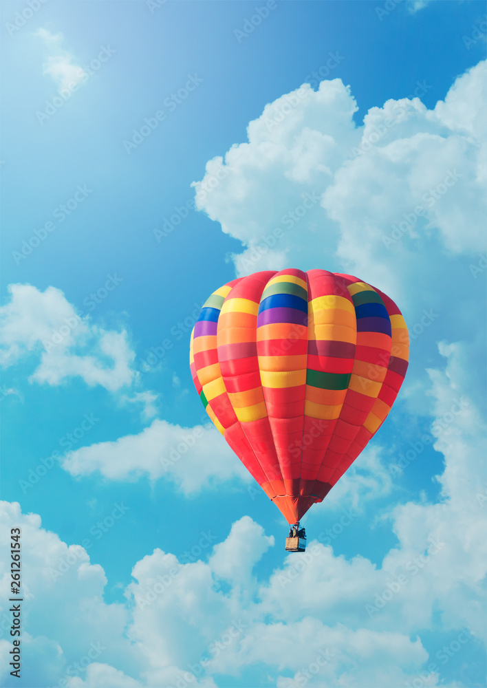 Fototapeta premium Red air balloon on background of blue sky and clouds