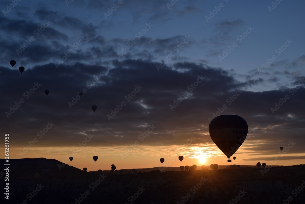 Sunrise and balloons. Beautiful background of the balloon and the sunset.Cappadocia. Turkey. Göreme. Nevşehir. Türkiye. 8. 04. 2019. Balloons flying over the rocky landscape in Cappadocia Turkey. View Sunrise and balloons. Beautiful background of the balloon and the sunset.Cappadocia. Turkey. Göreme. Nevşehir. Türkiye. 8. 04. 2019. Balloons flying over the rocky landscape in Cappadocia Turkey. View
