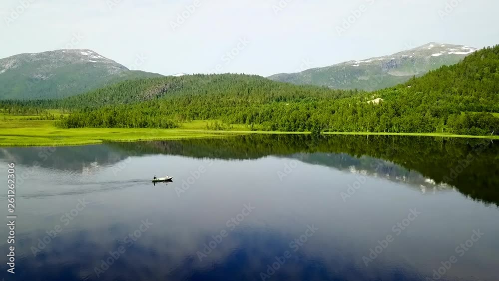 Aerial Forward: Boat on Beautiful Lake Among Scenic Green Mountains in Senja Island, Norway Aerial Forward: Boat on Beautiful Lake Among Scenic Green Mountains in Senja Island, Norway
