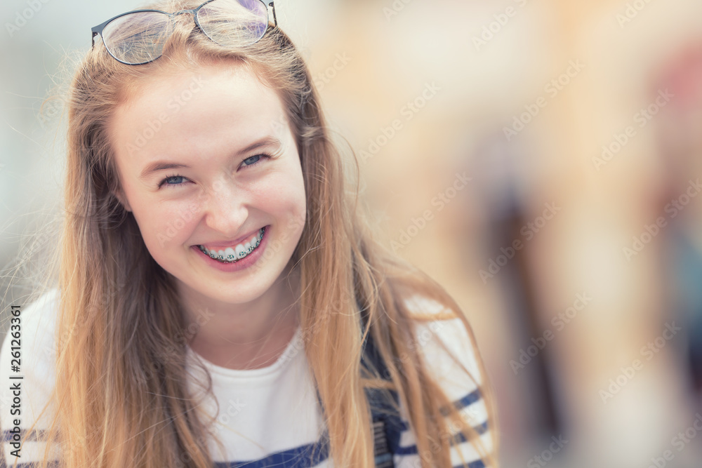 Portrait of a smiling beautiful teenage girl with dental braces