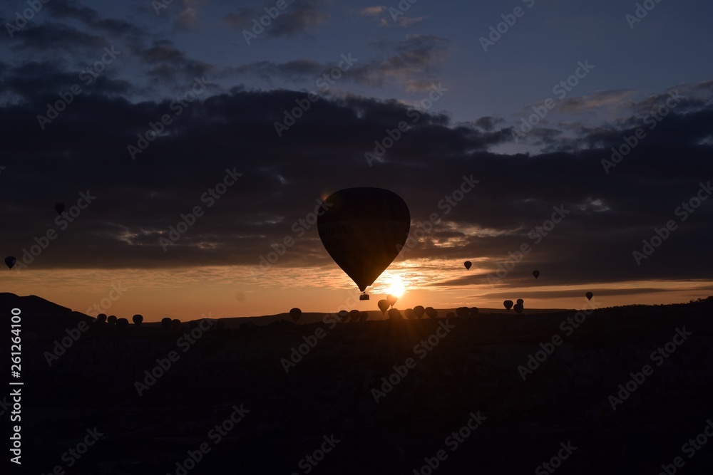 Sunrise and balloons. Beautiful background of the balloon and the sunset.Cappadocia. Turkey. Göreme. Nevşehir. Türkiye. 8. 04. 2019. Balloons flying over the rocky landscape in Cappadocia Turkey. View Sunrise and balloons. Beautiful background of the balloon and the sunset.Cappadocia. Turkey. Göreme. Nevşehir. Türkiye. 8. 04. 2019. Balloons flying over the rocky landscape in Cappadocia Turkey. View