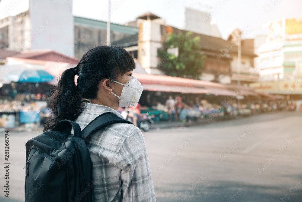 Woman with a mask because of air pollution in the city