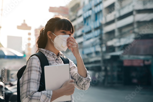 Woman with a mask because of air pollution in the city