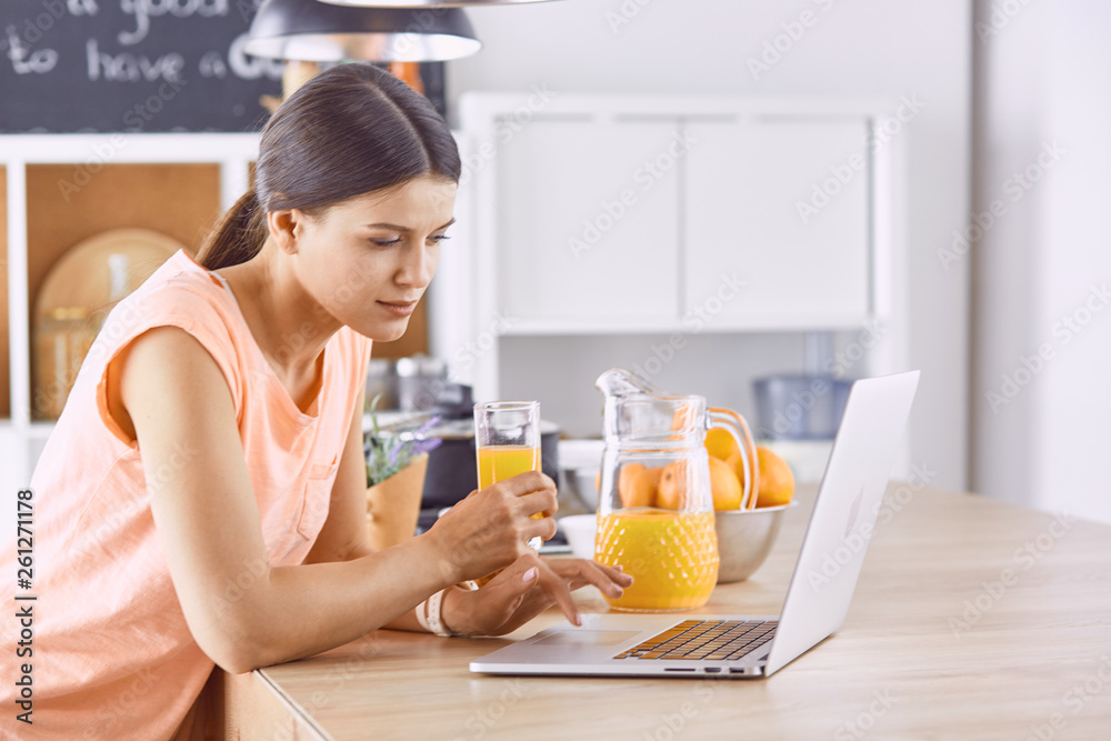 Smiling pretty woman looking at mobile phone and holding glass Smiling pretty woman looking at mobile phone and holding glass
