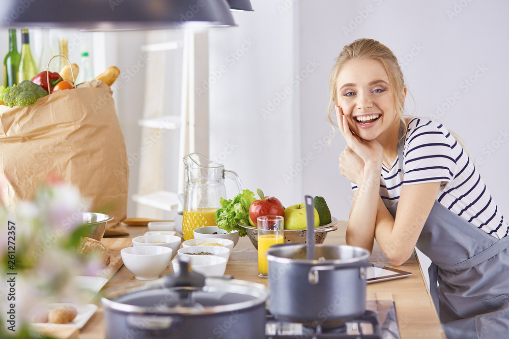 Young Woman Cooking in the kitchen. Healthy Food