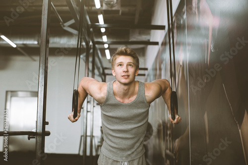 Sports Man Training With Gymnastics Rings At Gym