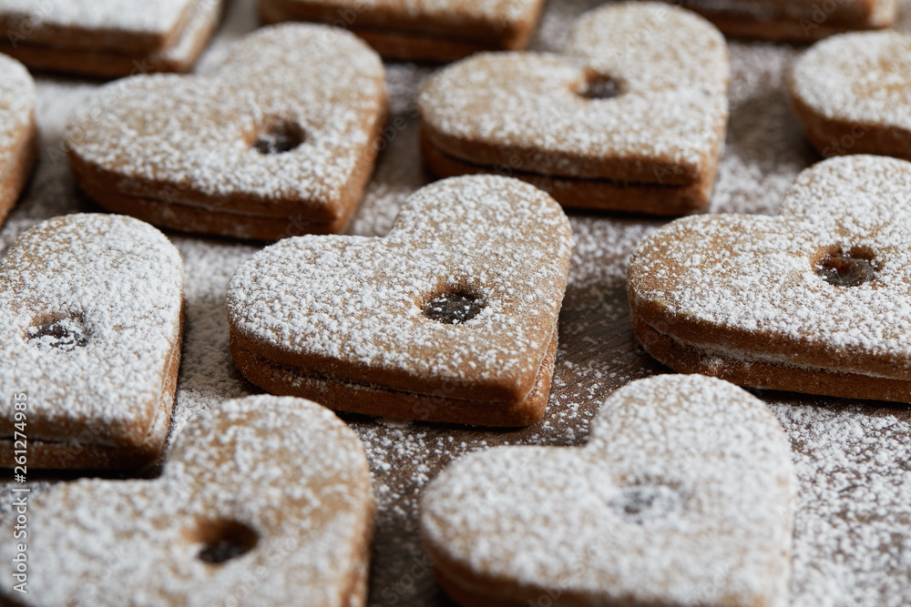 Close up of freshly baked homemade Christmas sugar cookies with jam on a wooden background Close up of freshly baked homemade Christmas sugar cookies with jam on a wooden background