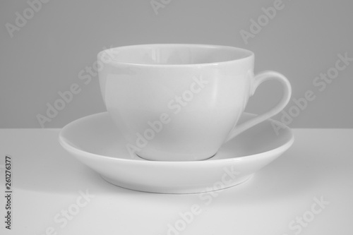 White mug and saucer on a white background.