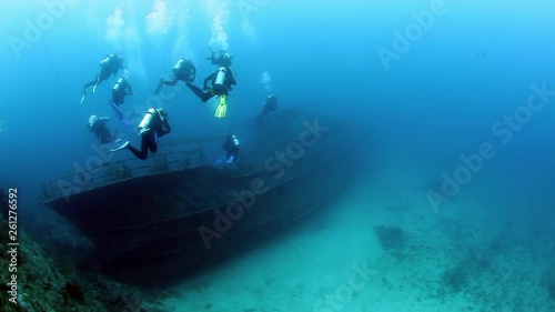 Wallpaper Mural Group of divers swims near ship wreck underwater. Sunken ship covered in coral on Pacific Ocean seabed in Fiji. Torontodigital.ca