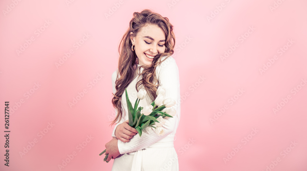 Young girl with tulips on a colored background Young girl with tulips on a colored background